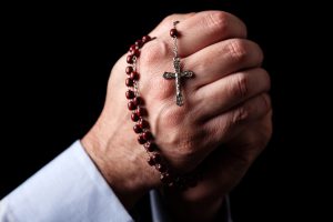 Rosary in Praying Hands